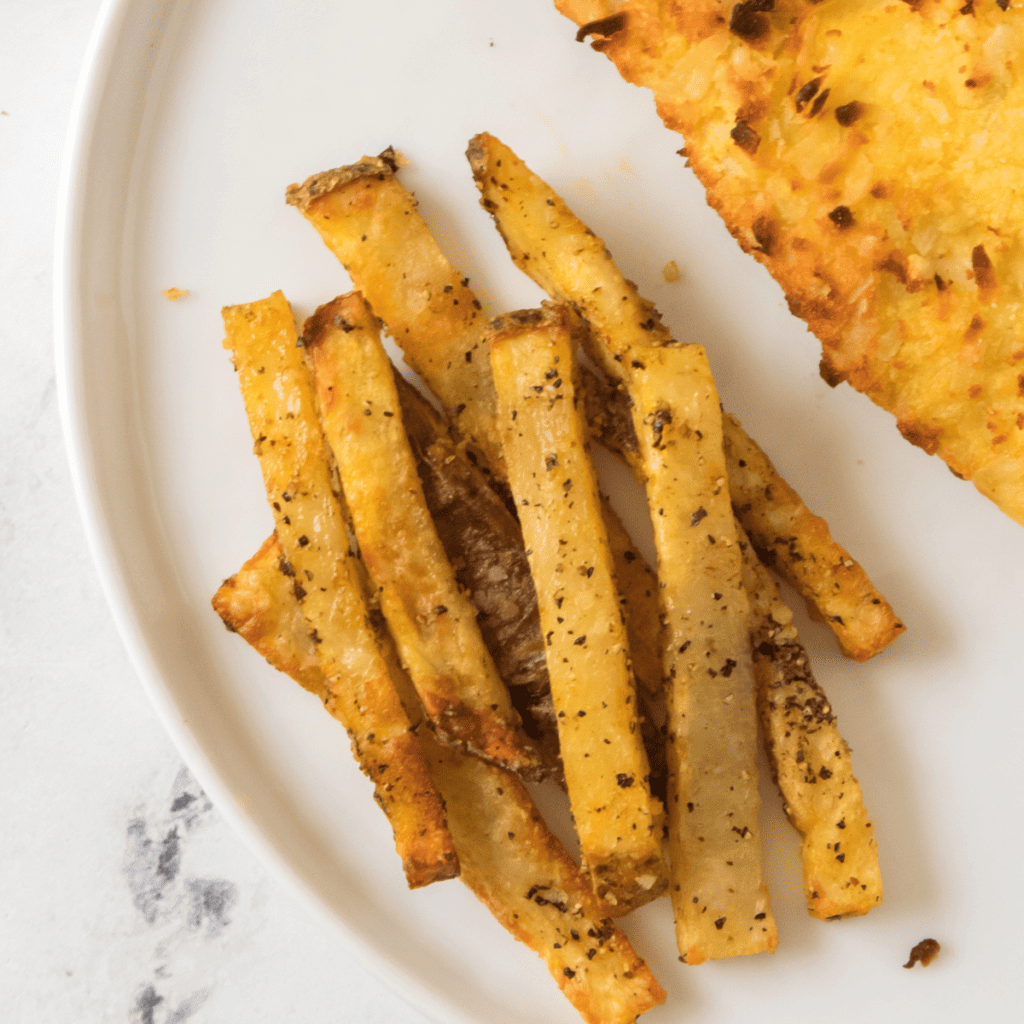 Close-up of a serving of Copycat Five Guys Cajun Fries, highlighting the spices and texture.