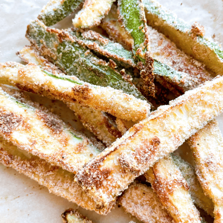 A plate of crispy, golden Copycat Carrabba’s Zucchini, served with a side of dipping sauce.