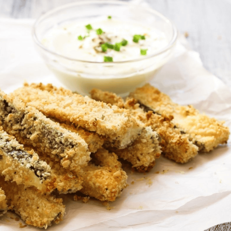 Plates of perfectly seasoned Copycat Carrabba's Zucchini served as a delicious side dish.
