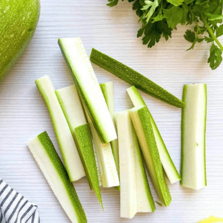 Wash, trim, and cut two large zucchinis into small pieces, either sticks or rounds.