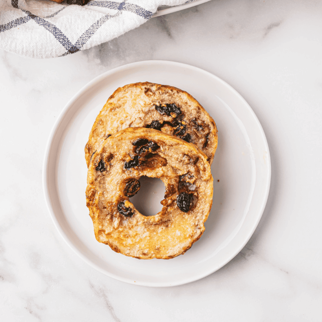 Close-up of air fryer cinnamon raisin bagels with visible raisins and a crispy exterior