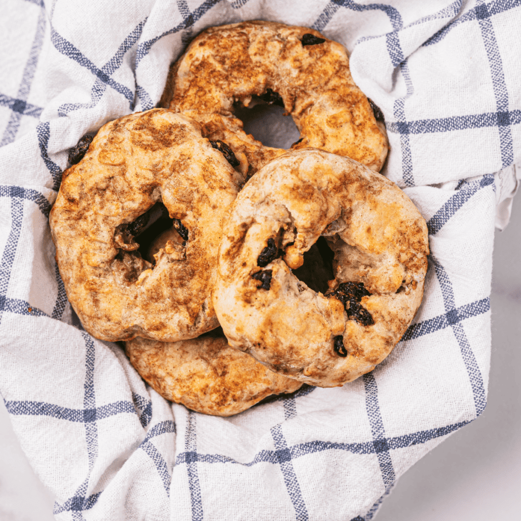 Plate of air fryer Dunkin' Donuts-style cinnamon raisin bagels, showcasing their delicious, homemade look