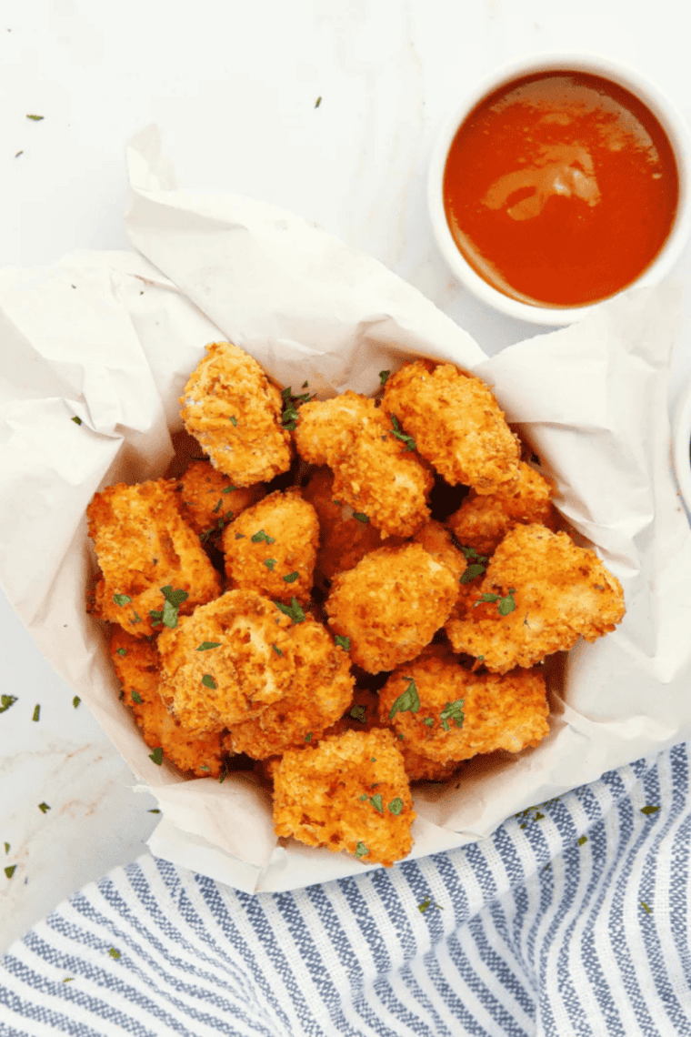 Air fryer copycat KFC popcorn chicken served crispy and golden with dipping sauces.