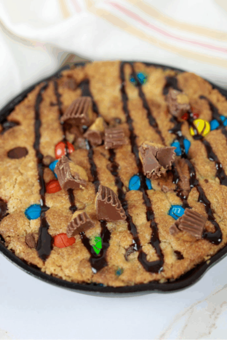 Air Fryer Peanut Butter Pizzokie with golden edges, soft gooey center, and chocolate-peanut butter candy mix