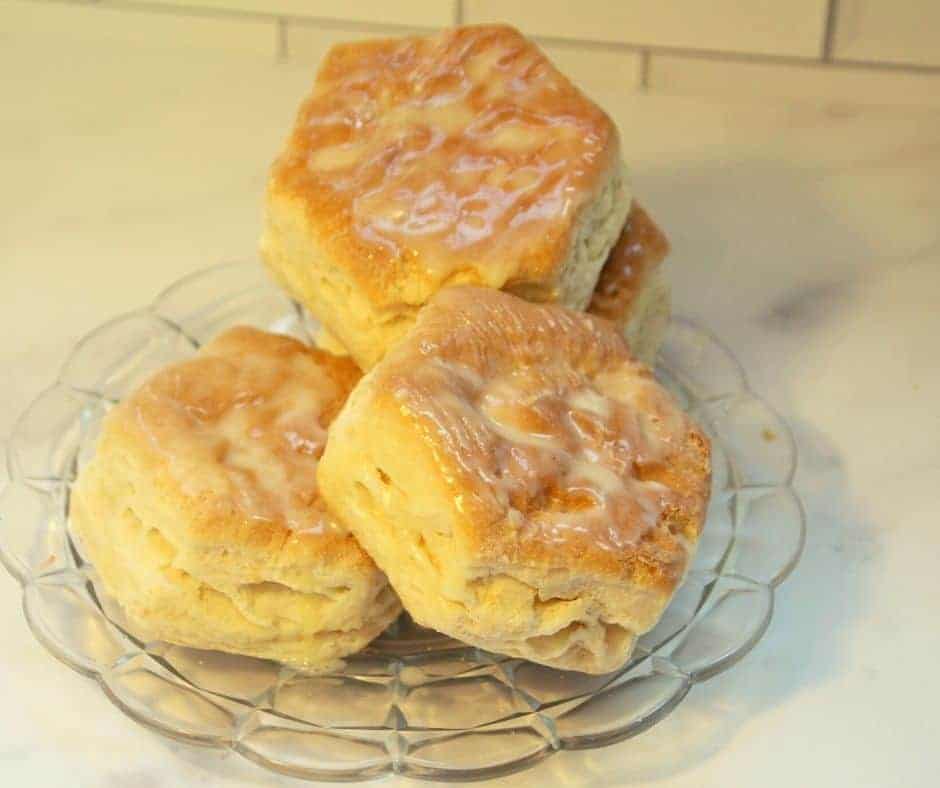 a glass plate full of frozen biscuits in the air fryer