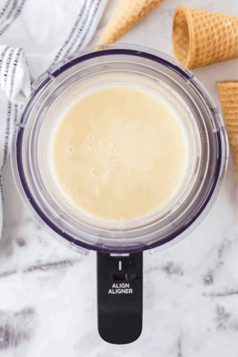 Close-up of creamy homemade vanilla bean ice cream scooped into a waffle cone