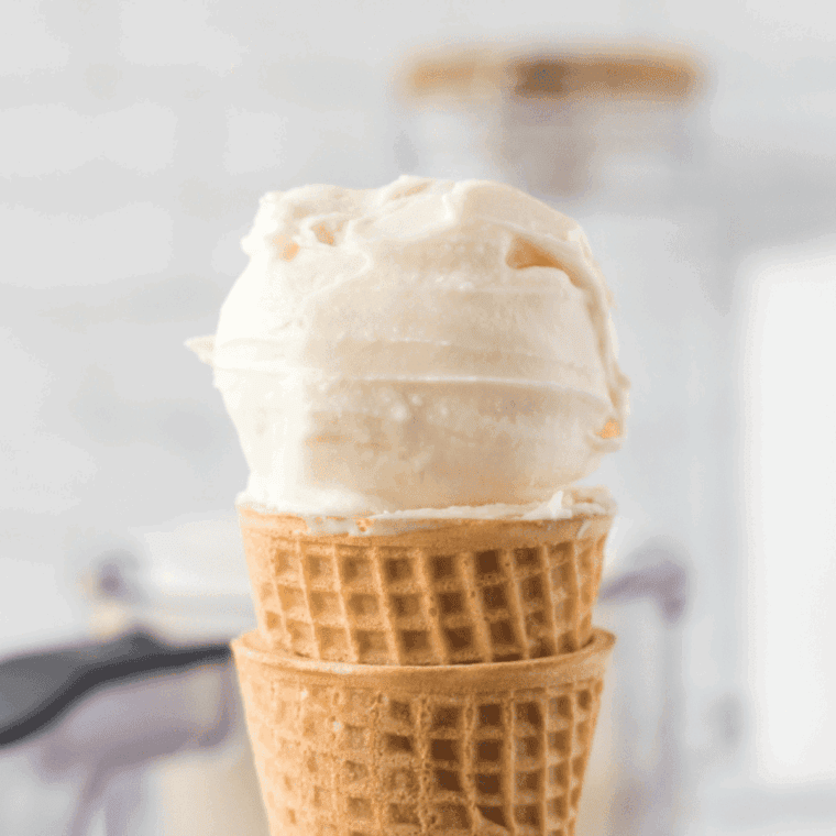 Ninja Creami vanilla bean ice cream scooped into a glass bowl, flecked with real vanilla bean specks