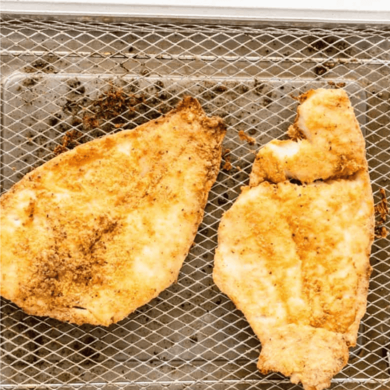 Cooked Popeyes Fish Sandwich Copycat Recipe on air fryer tray.