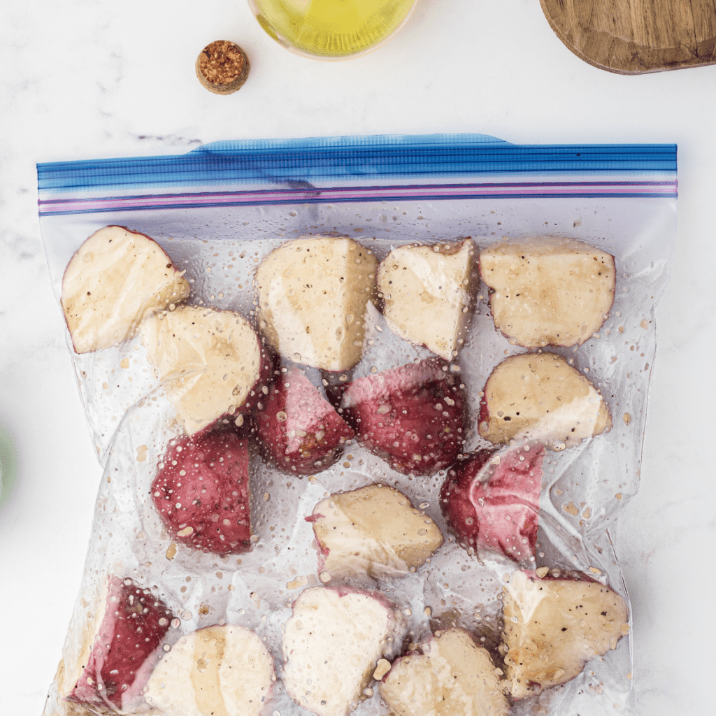 Preheat the air fryer to 400°F (200°C) for a few minutes. In a large mixing bowl, combine the halved baby potatoes with olive oil, garlic powder, onion powder, paprika, salt, and pepper. Toss until the potatoes are evenly coated with the seasonings. Place the seasoned potatoes in a single layer in the air fryer basket. Air fry the potatoes at 400°F (200°C) for 15-20 minutes, shaking the basket halfway through the cooking time to ensure even cooking. The potatoes should be golden brown and fork-tender when done. Once the potatoes are cooked, remove them from the air fryer and let them cool slightly.