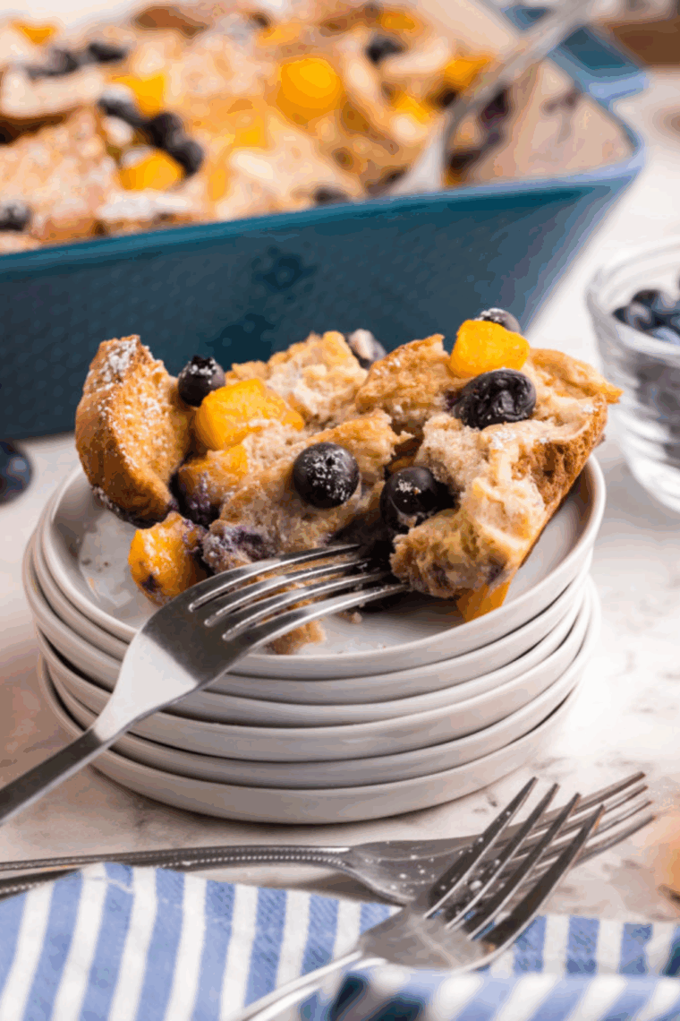A slice of air fryer French toast casserole served with fresh fruit