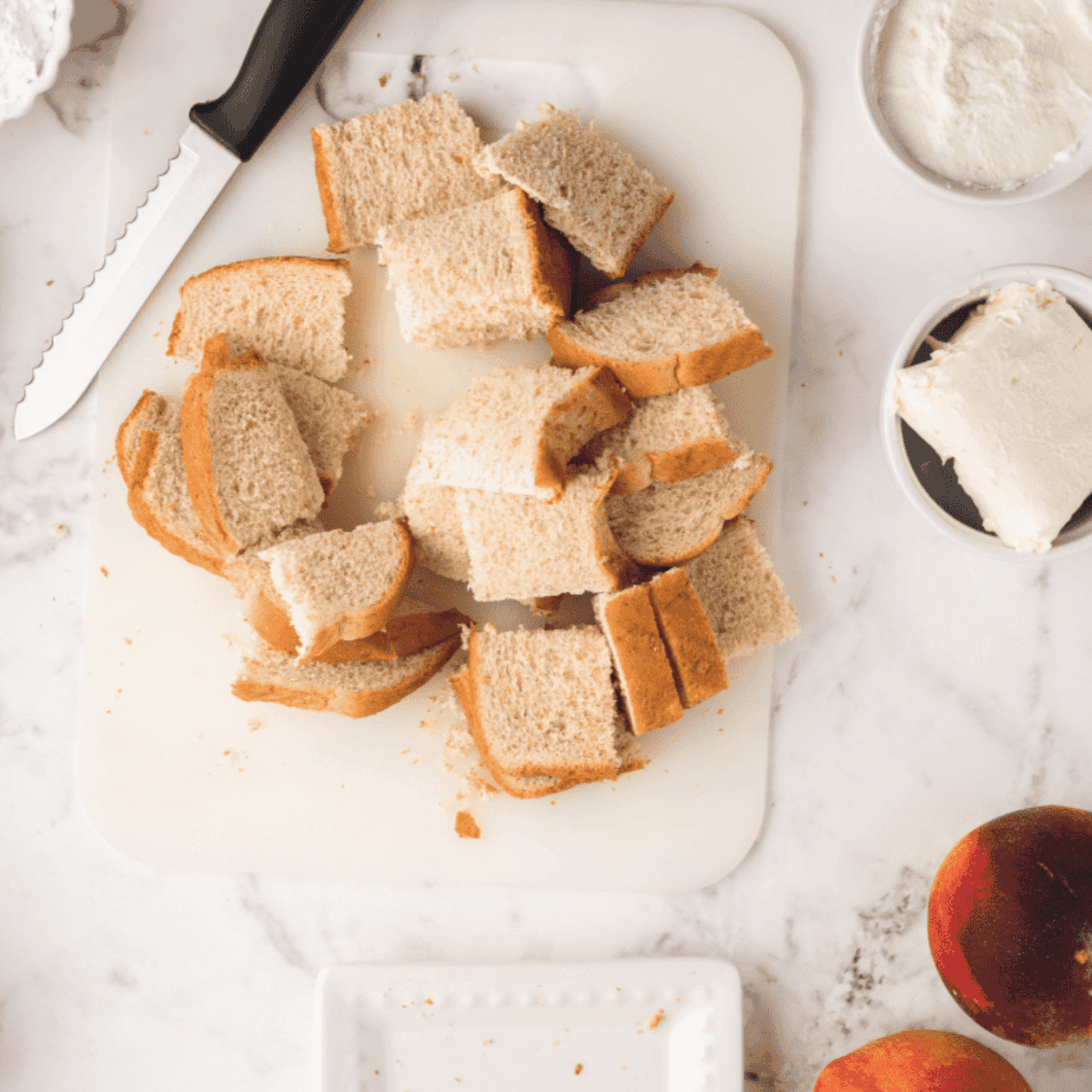 Cubing bread for air fryer French toast casserole on a cutting board