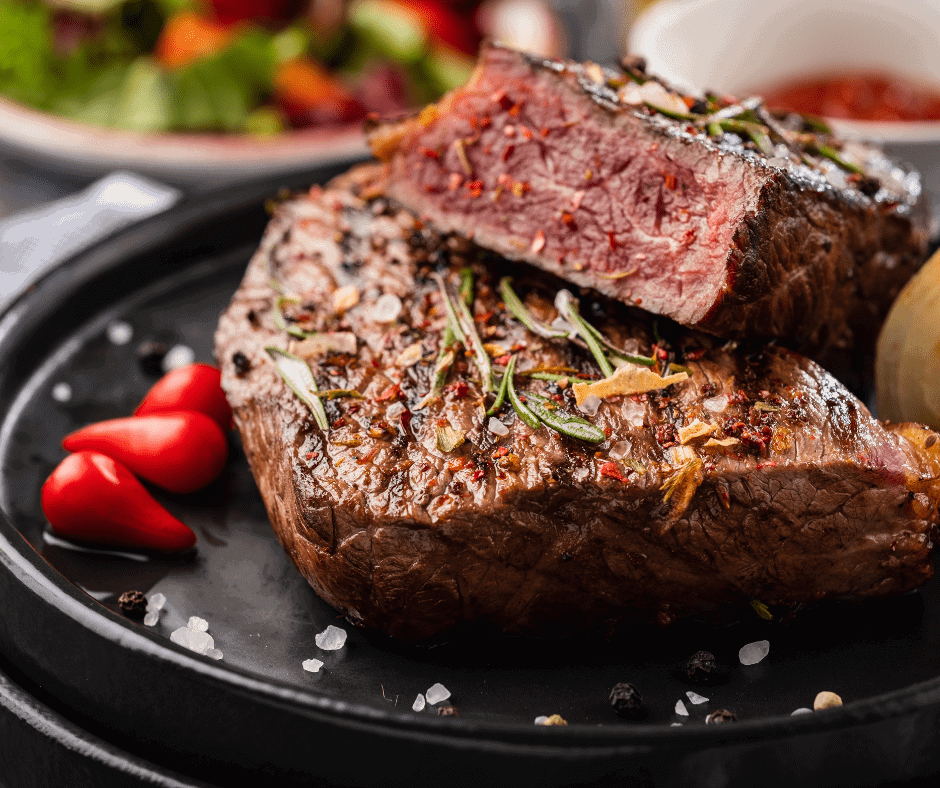 steak in ninja foodi grill recipe on a plate with herbs on top