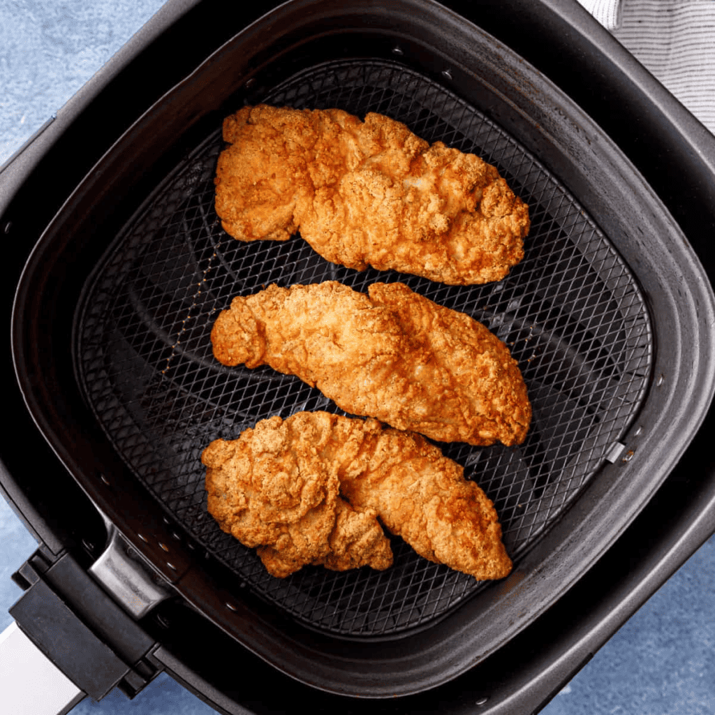 Tyson Southern Style Chicken Tenderloins in air fryer basket. After cooking.