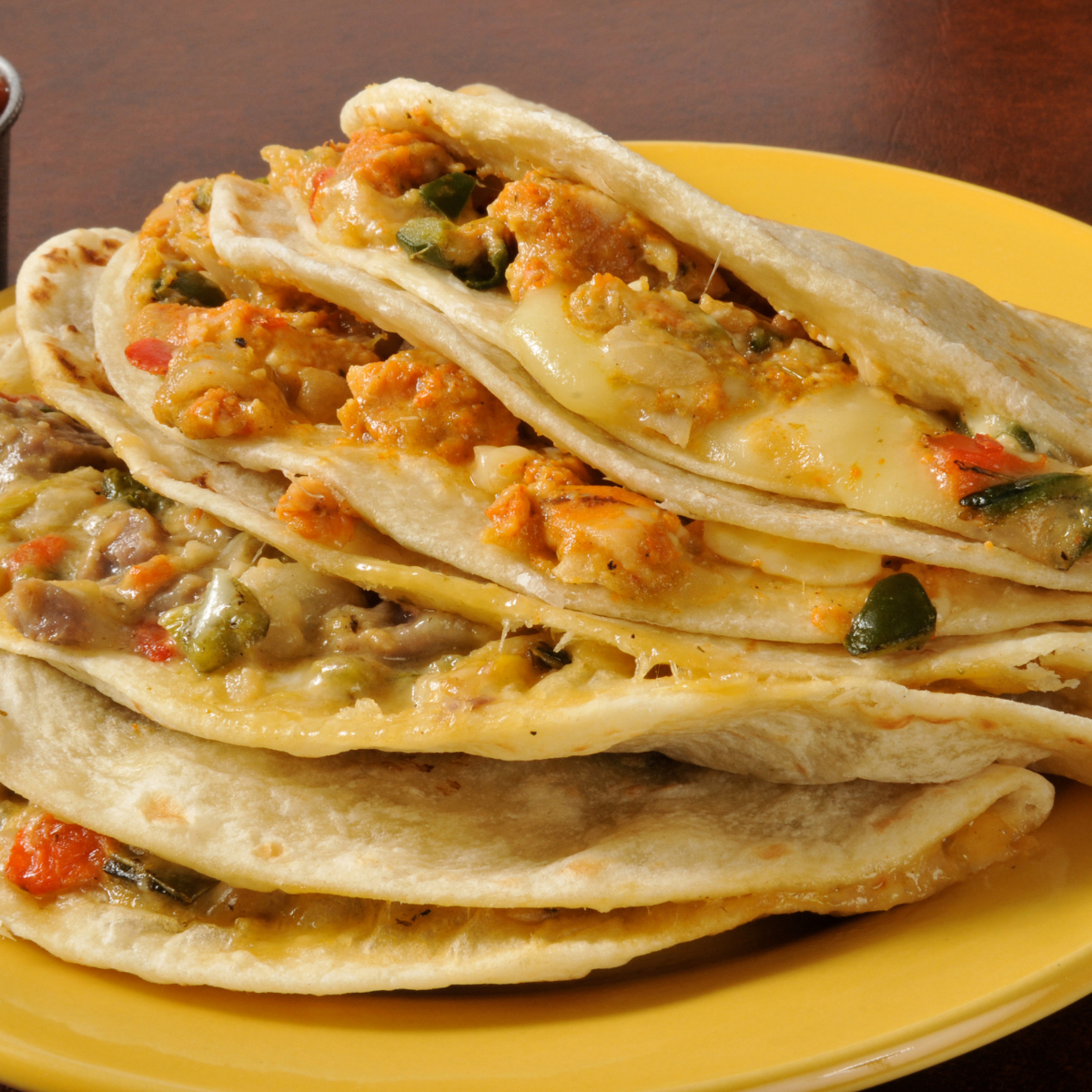 To achieve the best results when cooking chicken quesadillas in an air fryer, consider the following tips: Preheat the Air Fryer: Preheating the air fryer is important to ensure that it reaches the desired cooking temperature. This helps in achieving a crispy texture on the quesadillas. Use Tortillas that Fit the Air Fryer: Select tortillas that fit comfortably within the dimensions of your air fryer basket or tray. This will allow for even cooking and prevent the edges from becoming too crispy or burnt. Layer the Ingredients Properly: Layer the ingredients of the quesadilla in the following order: tortilla, cheese, cooked chicken, additional toppings (such as sautéed vegetables or salsa), and another layer of cheese. This helps the cheese to melt and bind the ingredients together. Avoid Overstuffing: Be mindful not to overstuff the quesadilla, as this can lead to the fillings spilling out during cooking. Leave enough space around the edges to prevent any leakage. Brush the Quesadilla with Oil: Lightly brush the top tortilla with oil before placing it in the air fryer. This helps to promote browning and create a crispy texture. Cook in Batches: If you're making multiple quesadillas, cook them in batches rather than overcrowding the air fryer. This allows for better air circulation and ensures each quesadilla cooks evenly. Monitor Cooking Time: Keep a close eye on the cooking time as air fryers can vary in their cooking efficiency. Check the quesadilla periodically to avoid overcooking or burning. Adjust the cooking time as needed based on the desired level of crispiness. Flip or Rotate the Quesadilla: To ensure even cooking and browning, consider flipping or rotating the quesadilla halfway through the cooking process. This helps to achieve a consistent texture and color on both sides. Let the Quesadilla Rest Before Cutting: Allow the cooked quesadilla to rest for a couple of minutes before slicing into it. This allows the cheese to set and makes it easier to handle without the fillings spilling out. By following these tips, you'll be able to prepare delicious and perfectly cooked chicken quesadillas in the air fryer. Experiment with different fillings, seasonings, and toppings to customize your quesadillas to your taste preferences. Enjoy the convenience and flavor of air-fried quesadillas in the comfort of your own home!