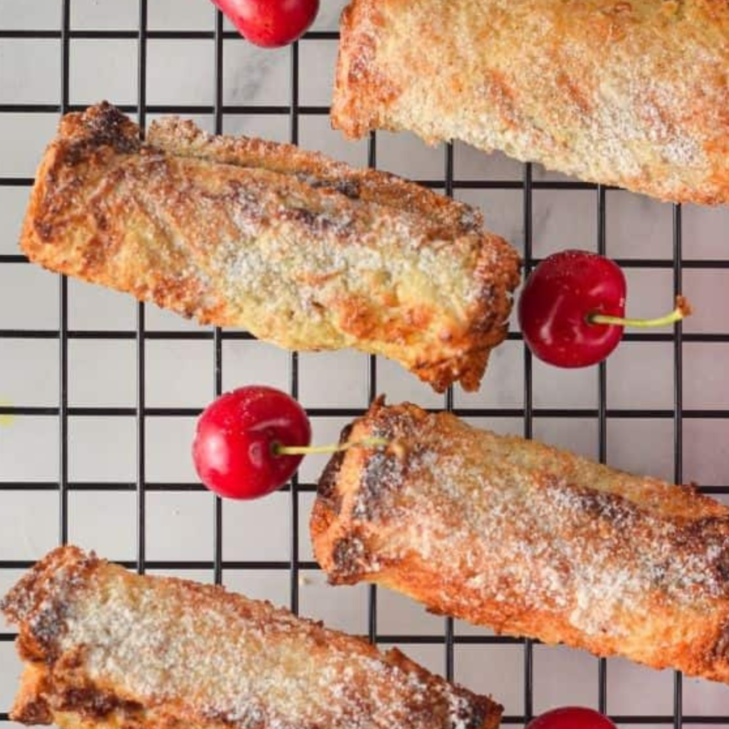 Cooking French Toast Roll-Ups in an air fryer can yield deliciously crispy and flavorful results. Here are some pro tips to enhance your cooking experience:
Use Stale Bread: For better absorption of the egg mixture, consider using slightly stale bread. It holds up better and prevents the roll-ups from becoming too soggy.
Flatten the Bread: Before spreading the filling and rolling up the bread, use a rolling pin to gently flatten the slices. This helps create a more even roll and makes it easier to seal the edges.
Secure the Edges: To prevent the filling from leaking out during cooking, make sure to press and seal the edges of the bread tightly before dipping in the egg mixture.
Optimize Egg Mixture: Whisk the eggs, milk, and vanilla extract together until well combined. For added flavor, you can incorporate spices like cinnamon or nutmeg into the egg mixture.
Preheat the Air Fryer: Preheating the air fryer helps ensure even cooking and crispiness. Give it a few minutes to reach the desired temperature before adding the roll-ups.
Grease the Basket or Tray: To prevent the roll-ups from sticking, lightly grease the air fryer basket or tray with cooking spray or melted butter before placing the roll-ups inside.
Arrange in a Single Layer: Make sure to arrange the French Toast Roll-Ups in a single layer in the air fryer, leaving enough space between them for proper air circulation. This ensures even cooking and browning.
Flip Halfway Through: To achieve an evenly crispy exterior, flip the roll-ups gently halfway through the cooking time. This ensures that both sides are cooked and golden brown.
Monitor Cooking Time: Keep a close eye on the roll-ups as they cook to prevent them from burning. Cooking times may vary depending on the air fryer model, so adjust accordingly.
Serve Fresh and Warm: French Toast Roll-Ups are best enjoyed fresh and warm. Serve them immediately after cooking to savor their crispy texture and delicious filling.
By following these pro tips, you can elevate your French Toast Roll-Ups in the air fryer and create a delightful breakfast or brunch treat. Customize the fillings and toppings to suit your preferences and get creative with flavors. Enjoy the crispy, golden exterior and the indulgent, gooey filling in every bite!