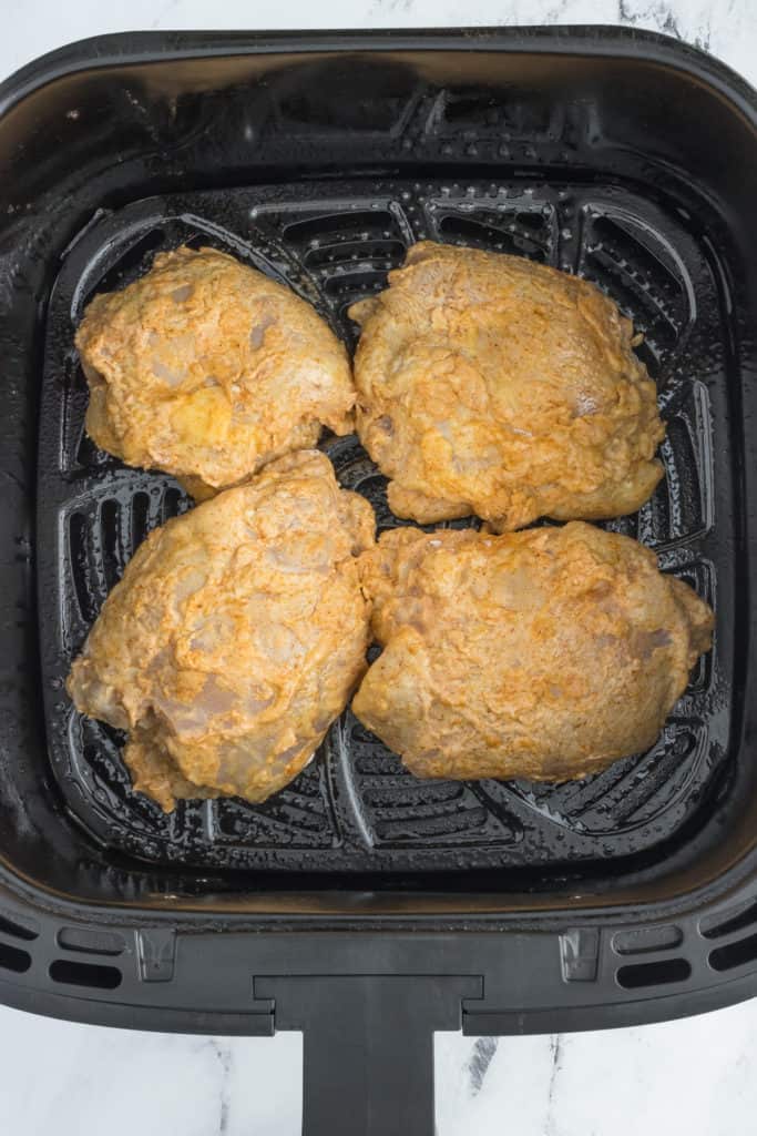 Crispy Air Fryer Hot Honey Chicken Sandwich in an air fryer basket, golden brown and ready to serve.