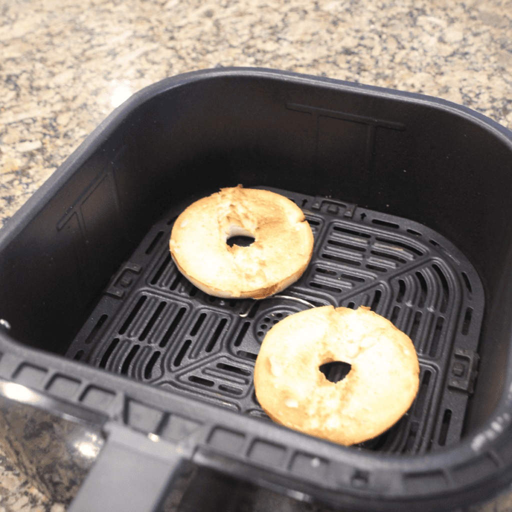 Air fryer basket with Lender's Bagels, showcasing their even browning and crispiness