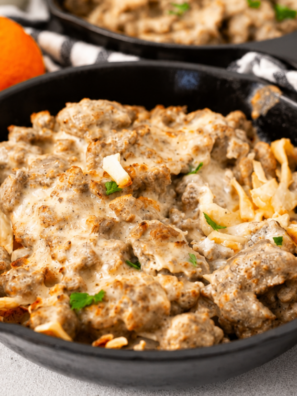 Air fryer sausage gravy breakfast skillet served on a plate, crispy hash browns topped with creamy homemade sausage gravy