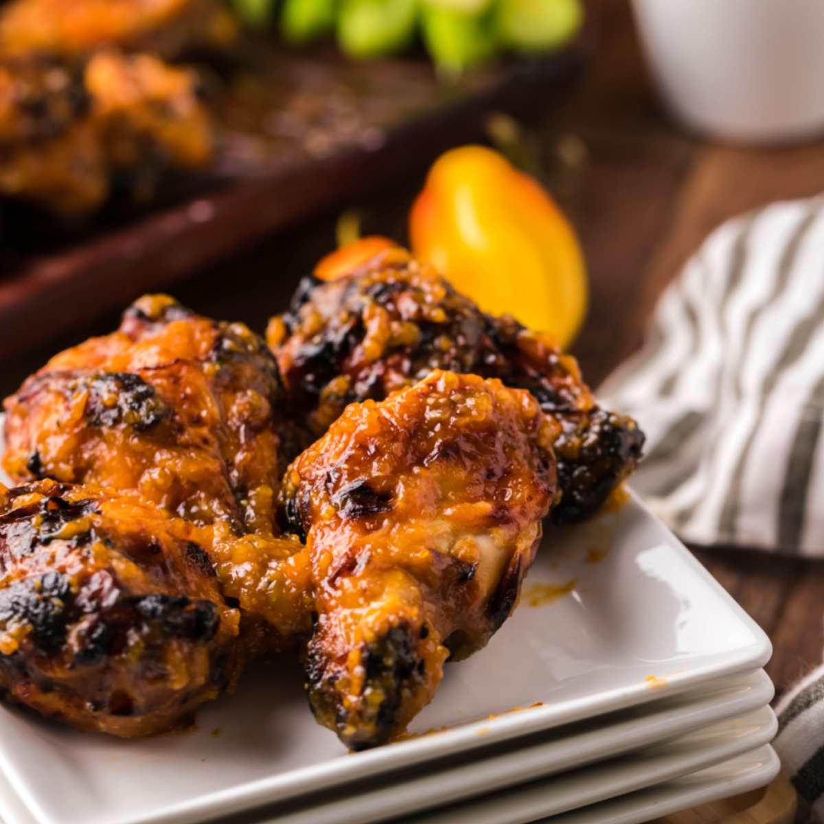 Plate of Air Fryer Spicy Apricot Glazed Chicken Wings, showcasing a crispy golden exterior and juicy interior, coated in a sweet and spicy apricot glaze.