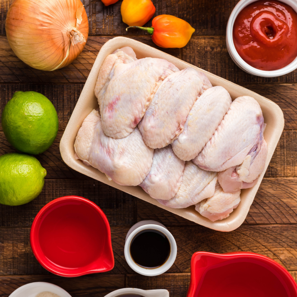 Ingredients needed for Air Fryer Spicy Apricot Glazed Wings on wooden table.