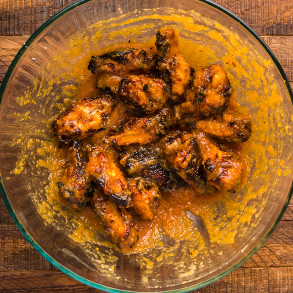 Mixing the wings with the apricot sauce, tossing well to coat.
