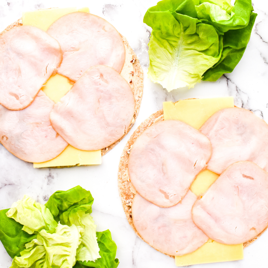 "Golden, crispy Air Fryer Turkey and Cheese Pinwheel Sandwiches filled with turkey, cheese, and sun-dried tomato spread, served fresh and ready to enjoy."