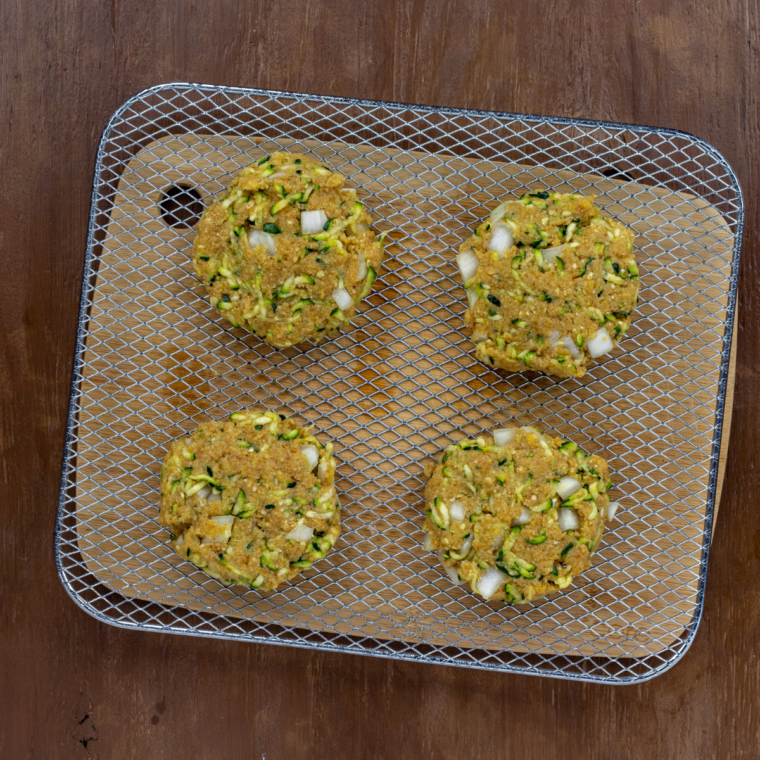 Shaping zucchini burger patties into four portions pressing firm and chilling in refrigerator to set before cooking
