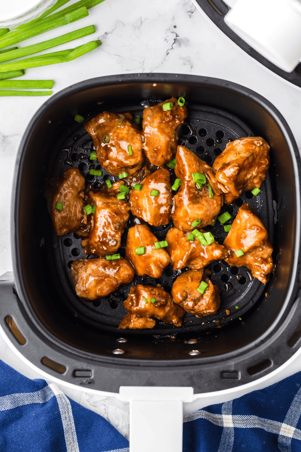 Air fryer Benihana-style teriyaki chicken served over rice, garnished with sesame seeds and green onions.