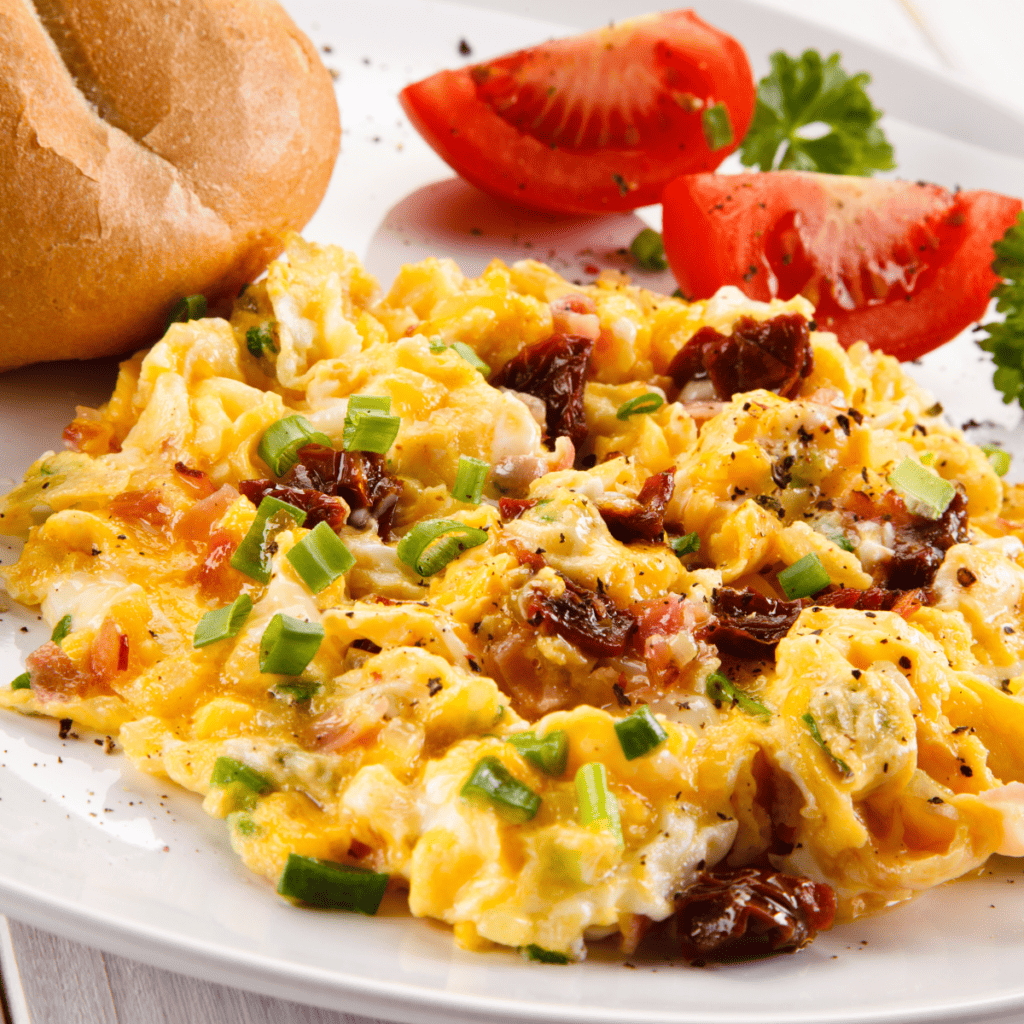 Fluffy scrambled eggs on the Blackstone griddle served in a cast iron skillet