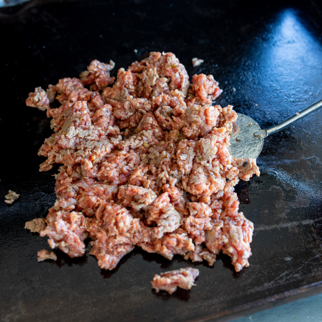 Preheating a Blackstone griddle with olive oil.