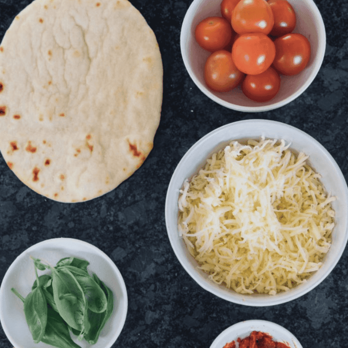 Ingredients needed for Cheesecake Factory Margherita Flatbread Pizza Recipe on kitchen table.