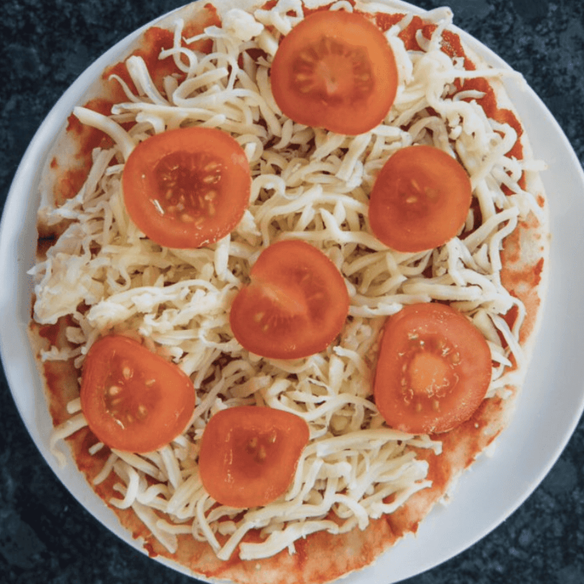 Add the toppings on top of your Cheesecake Factory Margherita Flatbread Pizza Recipe.