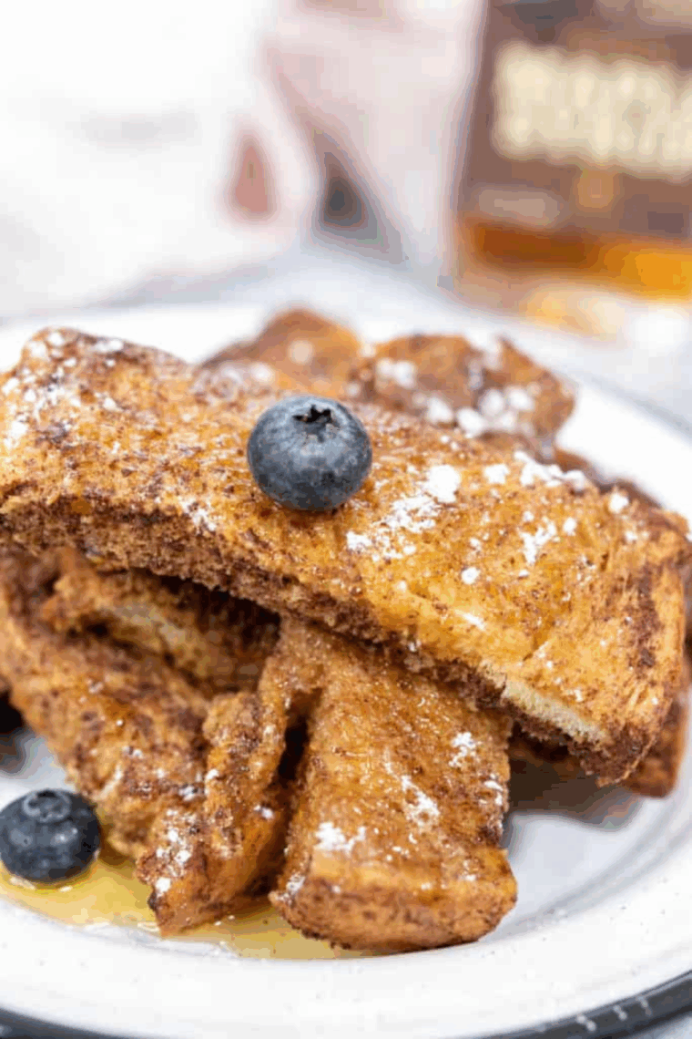 Homemade copycat Sonic French Toast Sticks cooked until golden brown and served with maple syrup for dipping.