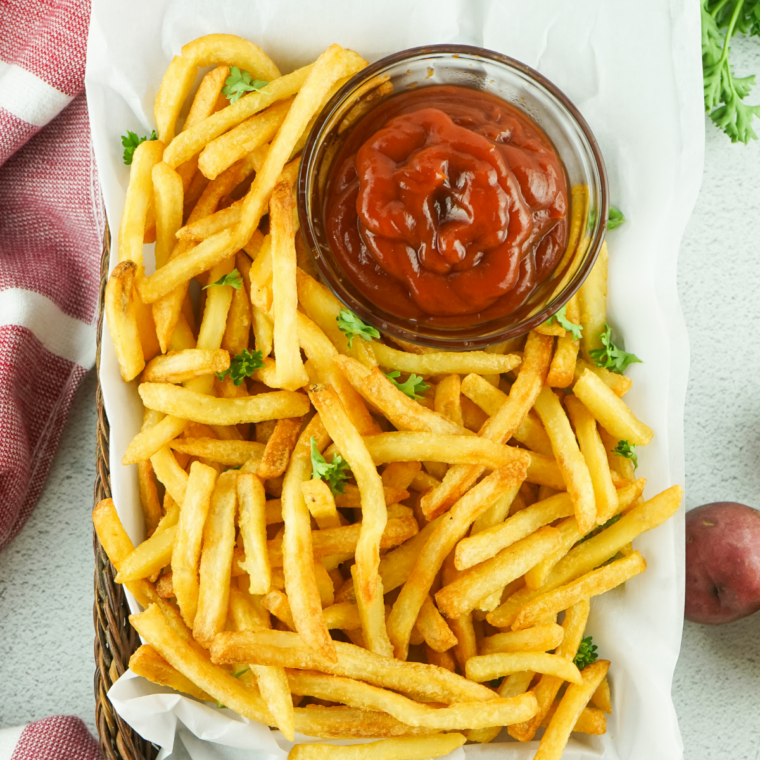 Crispy Blackstone griddle frozen french fries piled on a plate.