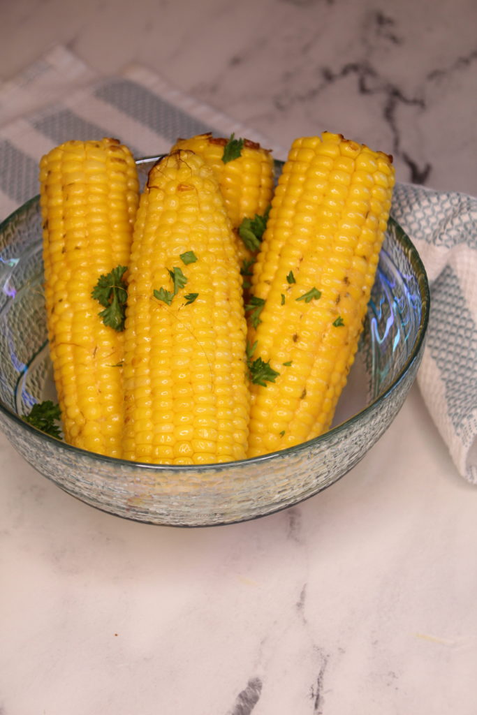 Can I grill corn on the cob directly from frozen in the Ninja Foodi Grill? A: It's generally recommended to thaw corn on the cob before grilling for the best results. Grilling frozen corn may result in uneven cooking and a less desirable texture. Thaw the corn by placing it in the refrigerator overnight or running it under cold water before grilling. Q: How long does it take to grill corn on the cob in the Ninja Foodi Grill? A: The cooking time for corn on the cob in the Ninja Foodi Grill can vary depending on factors such as the size of the corn and the temperature of the grill. In general, it takes about 10-12 minutes to grill corn on medium-high heat, turning occasionally to ensure even cooking. Keep a close eye on the corn and adjust the cooking time as needed. Q: Can I grill corn with the husks on in the Ninja Foodi Grill? A: Yes, you can grill corn with the husks on in the Ninja Foodi Grill. Soak the corn in water for a few minutes before grilling, then place it on the grill grates with the husks intact. The husks will help steam the corn, resulting in a tender and flavorful outcome. Q: Should I remove the silk from the corn before grilling? A: Yes, it's best to remove the silk from the corn before grilling. Peel back the husks, remove the silk strands, and then rewrap the husks around the corn. This allows the corn to cook evenly and prevents the silk from burning during grilling. Q: Can I season the corn before grilling? A: Absolutely! Seasoning the corn before grilling can enhance its flavor. Brush the corn with melted butter or olive oil and sprinkle it with salt, pepper, or your favorite seasonings to add a tasty kick. Q: Can I cook corn on the cob in foil packets on the Ninja Foodi Grill? A: Yes, you can cook corn on the cob in foil packets on the Ninja Foodi Grill. Wrap each ear of corn in aluminum foil, place them on the grill grates, and cook them for about 10-12 minutes. Foil packets help steam the corn, resulting in a tender and juicy texture. Q: Can I use the Ninja Foodi Grill to make Mexican street corn (elote)? A: Absolutely! The Ninja Foodi Grill is a great tool for making Mexican street corn. After grilling the corn, brush it with mayonnaise, sprinkle it with crumbled cheese (such as Cotija), and add a squeeze of lime juice. You can also sprinkle it with chili powder or paprika for added spice.