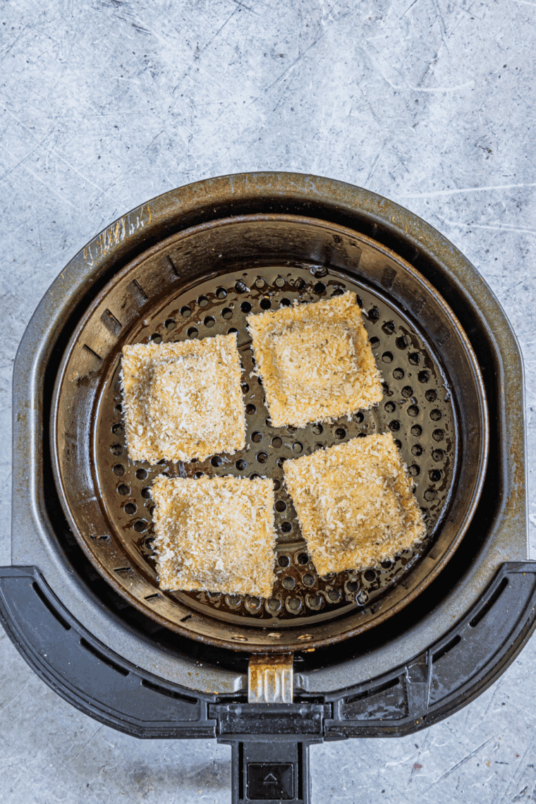 Low carb ravioli coated in oil and seasonings, arranged in a single layer in the air fryer basket, preheated to 375°F