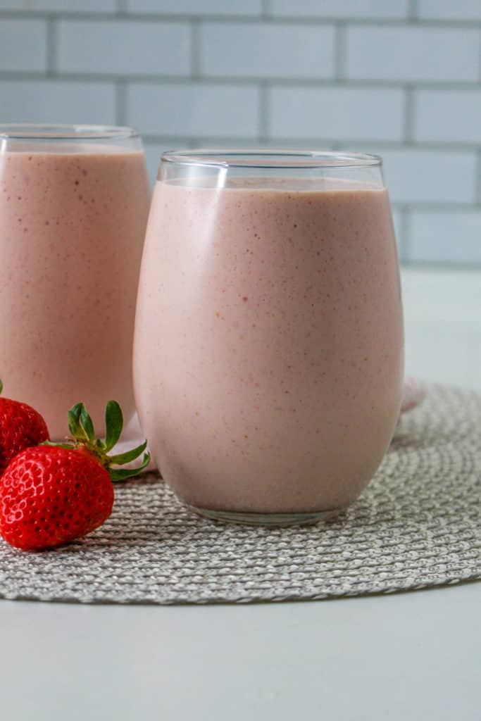 A refreshing Ninja Creami Peanut Butter and Jelly Smoothie, with a creamy texture and a hint of peanut butter and jelly flavors in a tall glass.