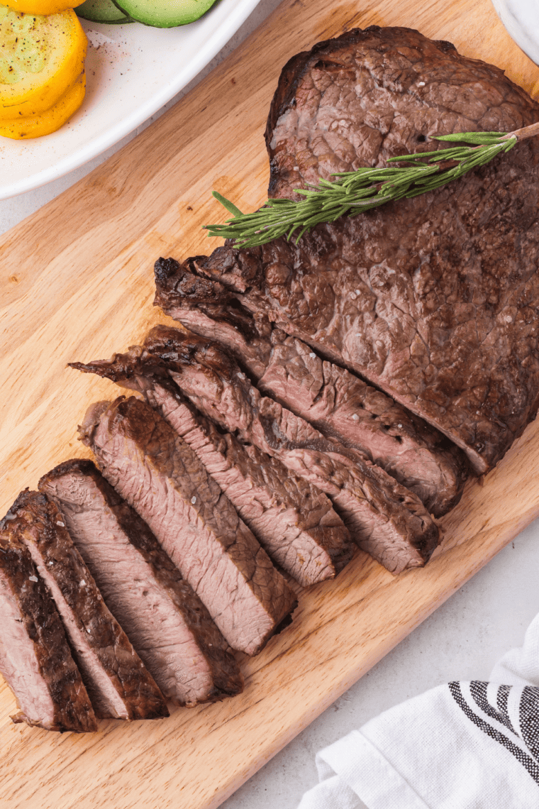 Perfectly seared Blackstone sirloin steak sliced and served with a juicy center on a griddle