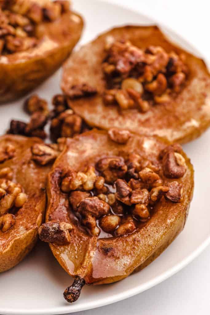 overhead closeup: air fried pears on a white plate with sugar, cinnamon, and nuts
