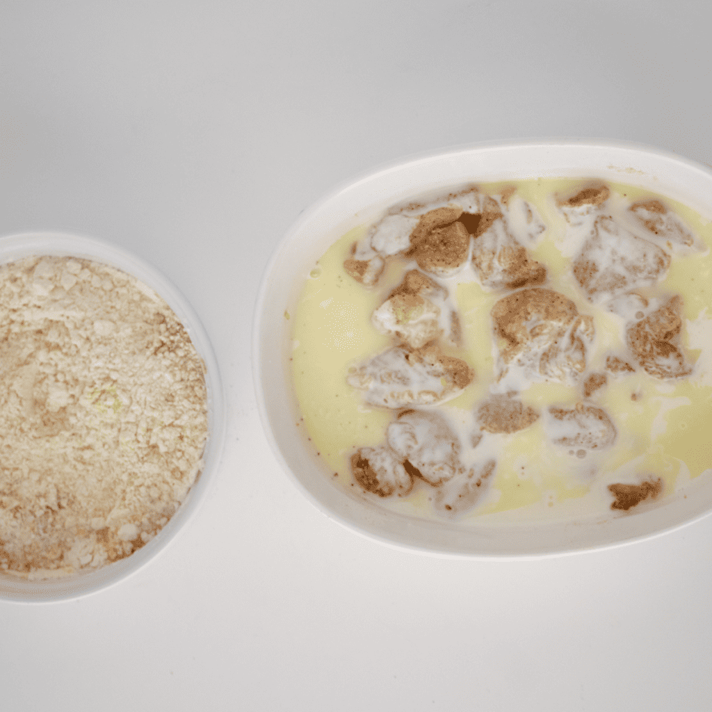 Sliced chicken marinating in milk and pickle juice for Chick-fil-A chicken minis