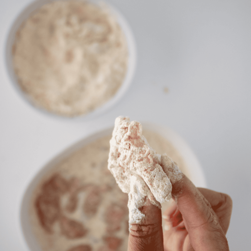 Marinated chicken dredged in seasoned flour breading for copycat chicken minis
