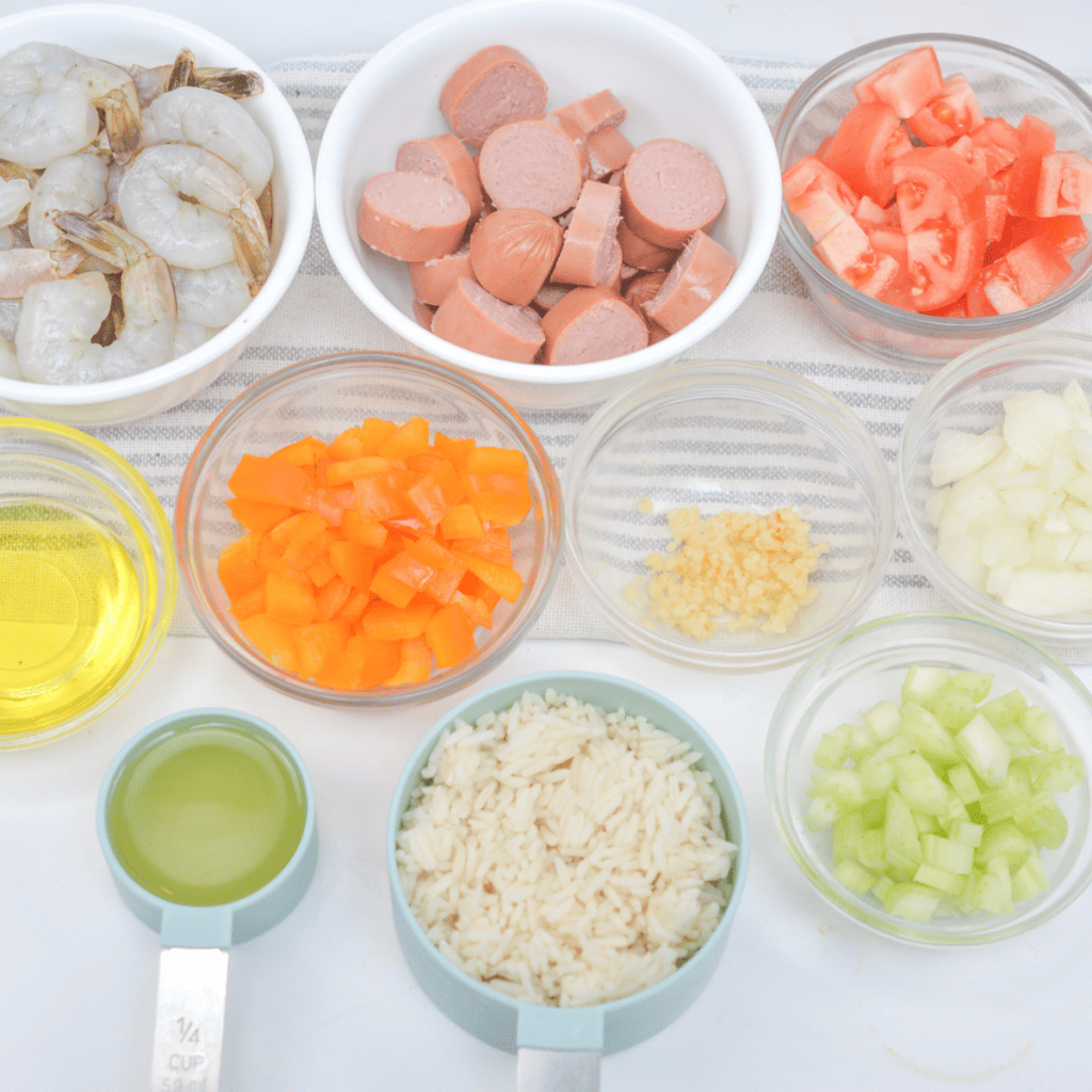 1 cup long-grain white rice: Use long-grain white rice for its fluffy texture that works well in the air fryer.
1 1/2 cups chicken or vegetable broth: The broth will cook the rice and infuse it with flavor.
1/2 lb large shrimp, peeled and deveined: Look for fresh or frozen large shrimp for this dish.
1/2 lb andouille sausage, sliced: Andouille sausage is a flavorful and spicy sausage that is a key ingredient in jambalaya.
1/2 onion, diced: Adds aromatic flavor to the dish.
1/2 green bell pepper, diced: Along with the onion, provides the classic "holy trinity" of Cajun and Creole cuisine.
2 cloves garlic, minced: Garlic adds a delicious depth of flavor.
1/2 can (7 oz) diced tomatoes, drained: Diced tomatoes bring acidity and slight sweetness to the dish.
1 tsp paprika: Provides smokiness and color to the jambalaya.
1/2 tsp dried thyme: Thyme adds an earthy and herbal note to the dish.
1/2 tsp dried oregano: Oregano contributes a savory and slightly bitter flavor.
1/4 tsp cayenne pepper (adjust to taste): Cayenne pepper brings the characteristic spiciness to the jambalaya. Adjust the amount based on your spice preference.
Salt and pepper, to taste: Season the dish with salt and pepper to enhance the flavors.
Olive oil: Used for sautéing the vegetables and coating the shrimp.
Fresh parsley, chopped (for garnish): Fresh parsley adds a burst of freshness and color to the finished dish.