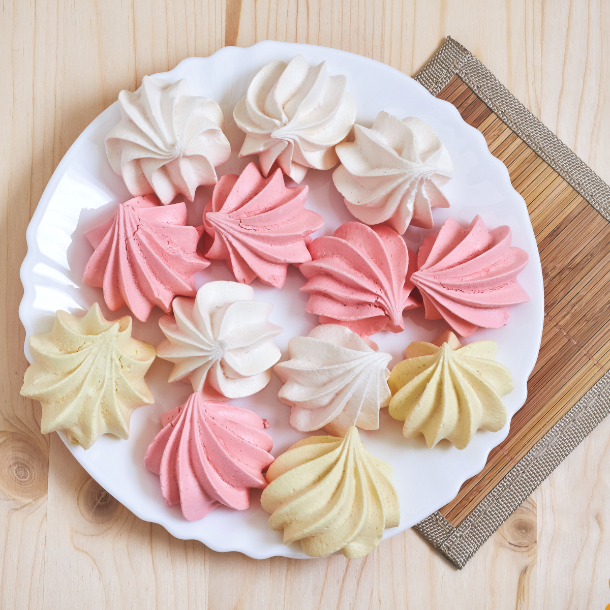 Light and airy Air Fryer meringue cookies arranged on a plate, showcasing their delicate texture and golden-brown edges.