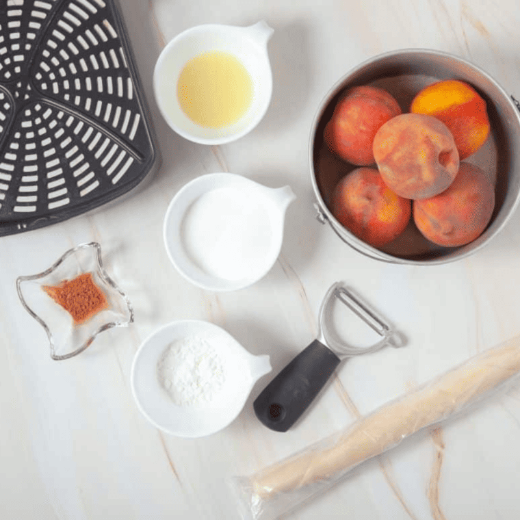 Ingredients needed for Air Fryer Peach Pie on kitchen table.