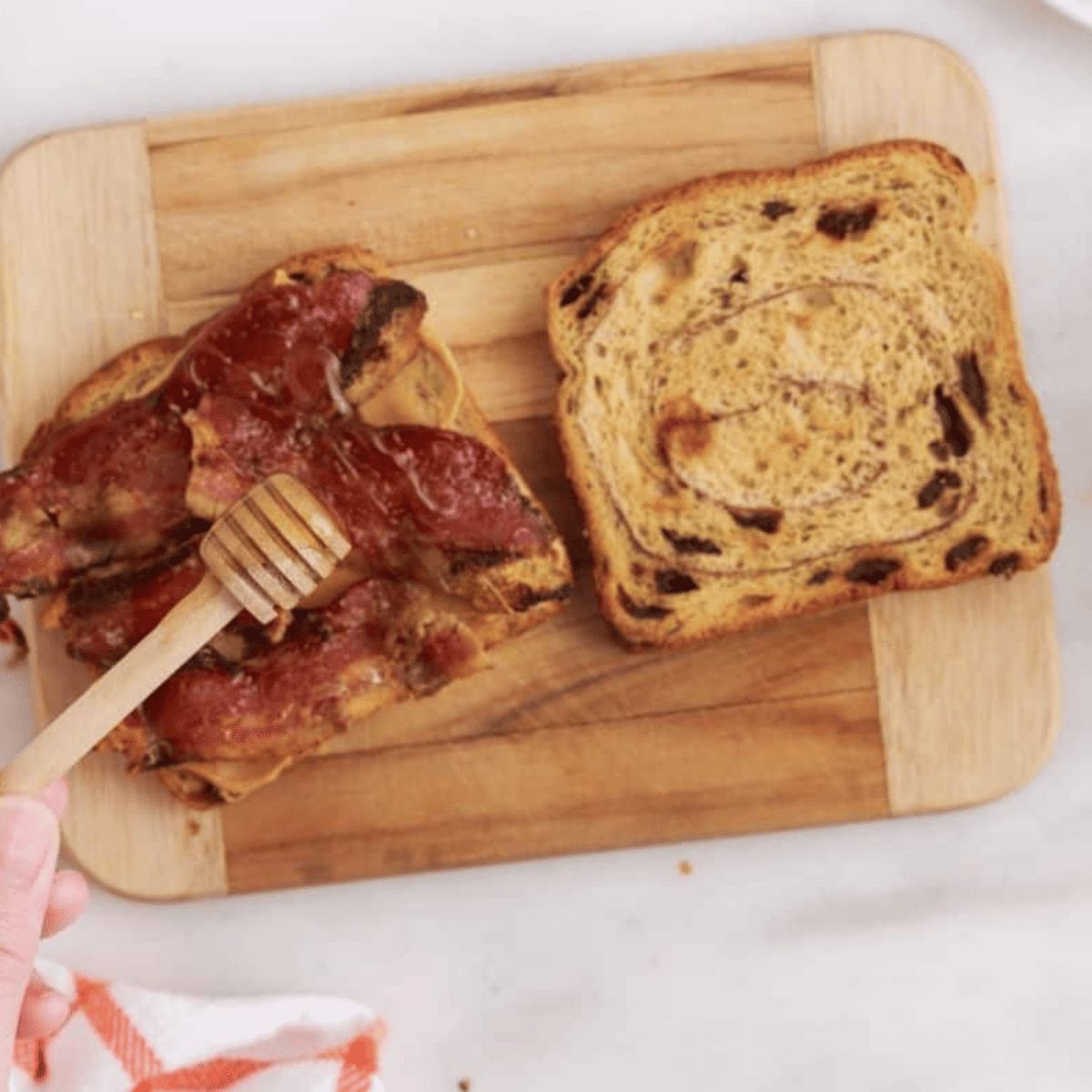 Spread peanut butter on bread, layer with bacon, drizzle honey, and top with another slice to assemble the sandwich.