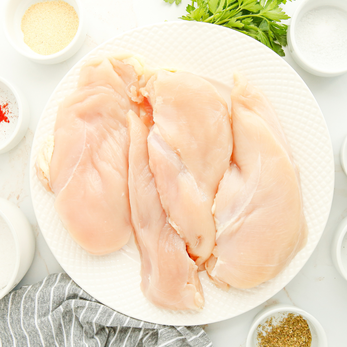 alt tag for ingreints
7:34 AM
Air fryer chicken Milanese ingredients on a counter: chicken breasts, panko, Parmesan, eggs, flour, cherry tomatoes, shallot, basil, and red wine