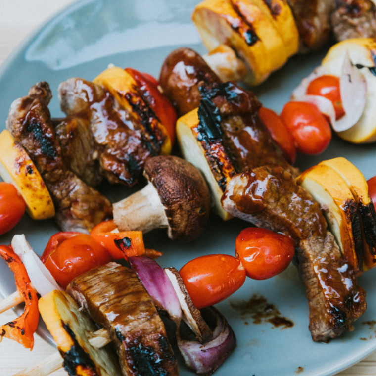 Juicy Blackstone beef kabobs with steak, peppers, and onions cooking on flat top griddle