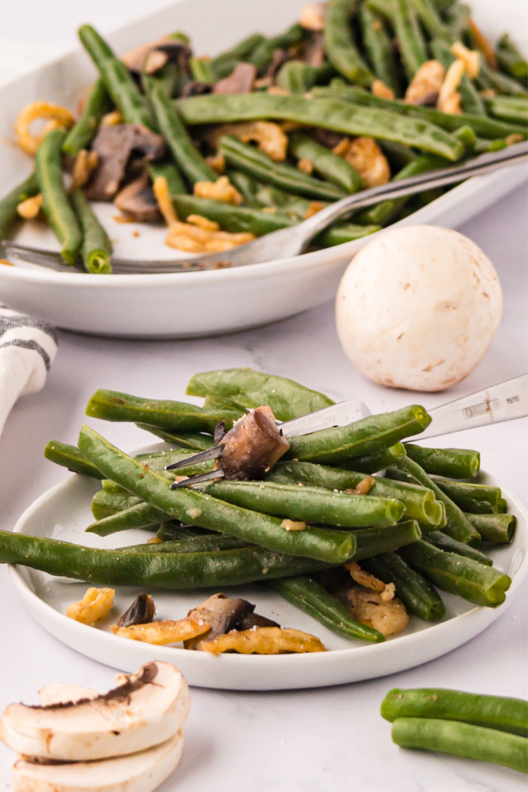 Fresh green beans cooking on a Blackstone griddle until tender and slightly charred