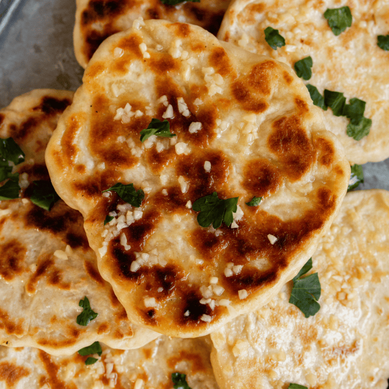 Golden brown Blackstone Naan, soft and fluffy, freshly cooked on the griddle