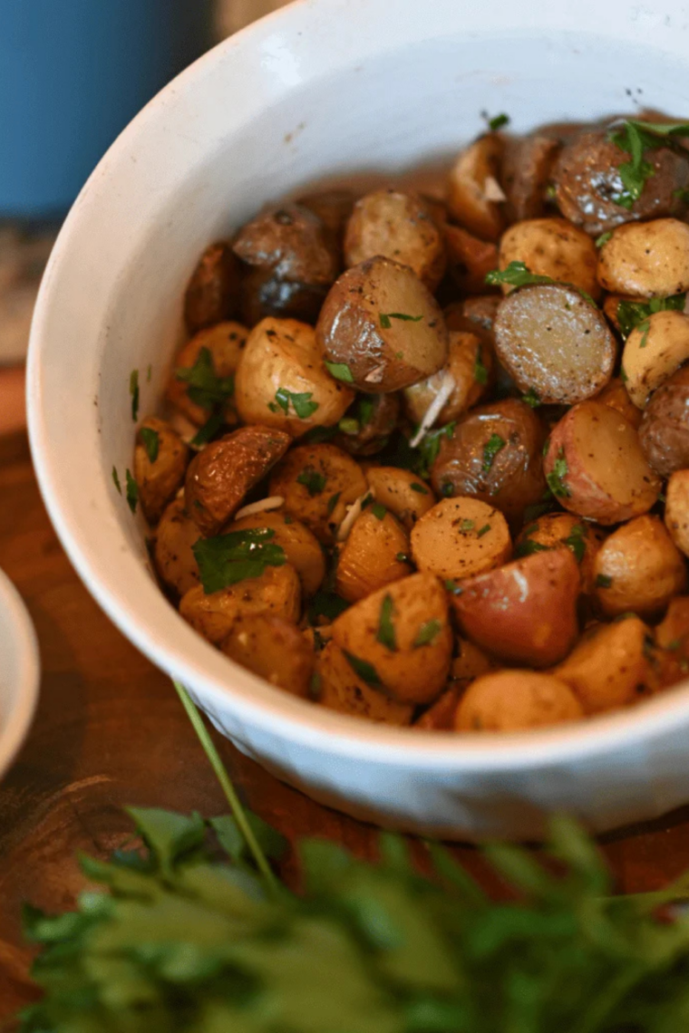 Seasoned diced potatoes cooking on Blackstone griddle until crispy